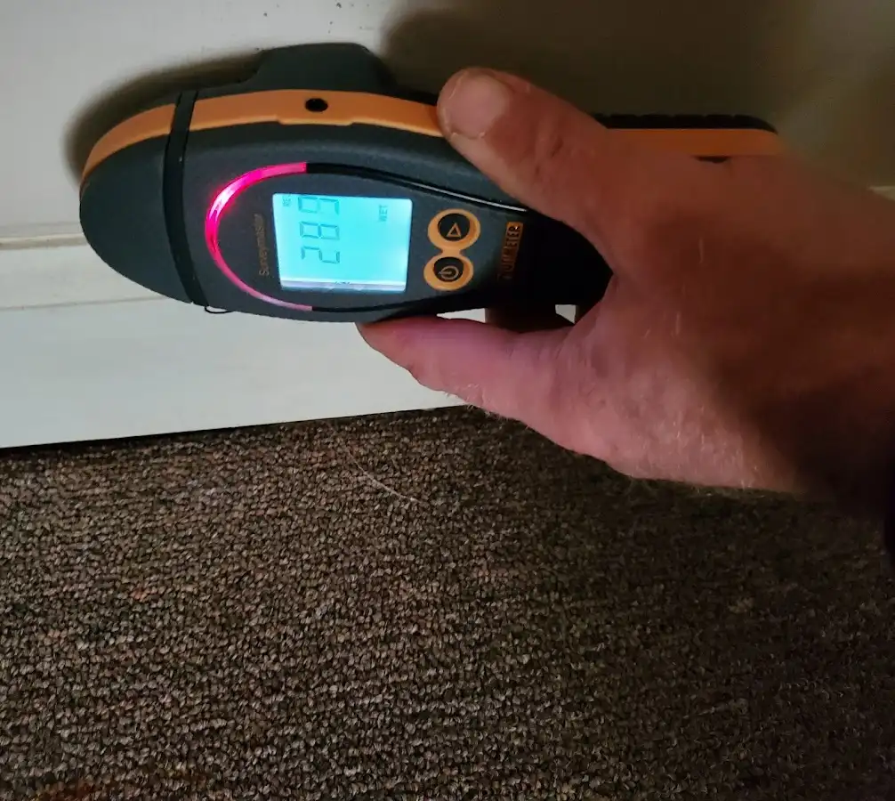 Moisture detection at baseboard during Storm Damage Restoration in Evanston